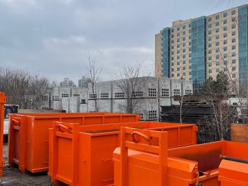Multiple orange dumpster bins at the Bins Toronto yard available for residential and commercial rental