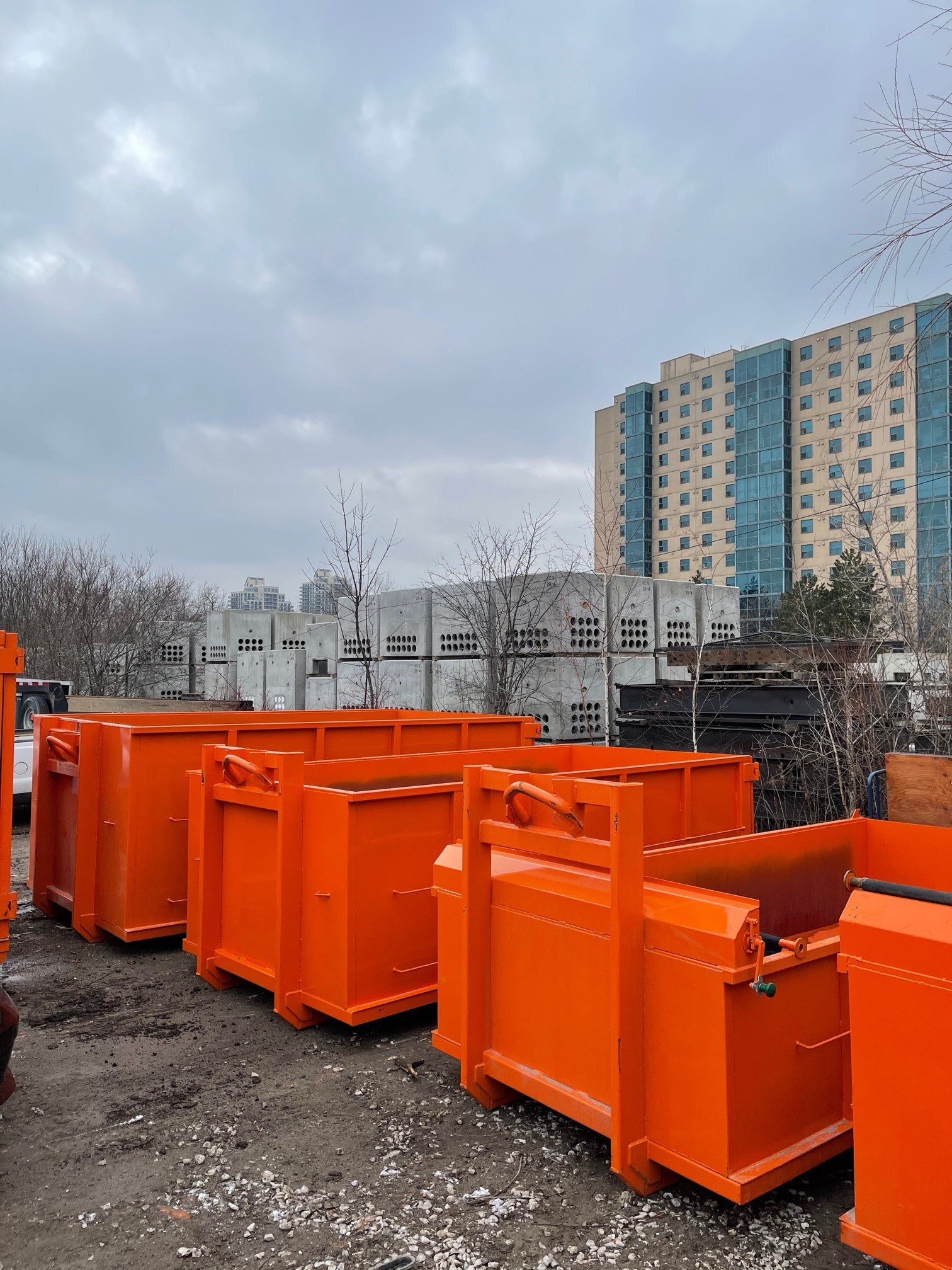 Multiple orange dumpster bins at the Bins Toronto yard available for residential and commercial rental
