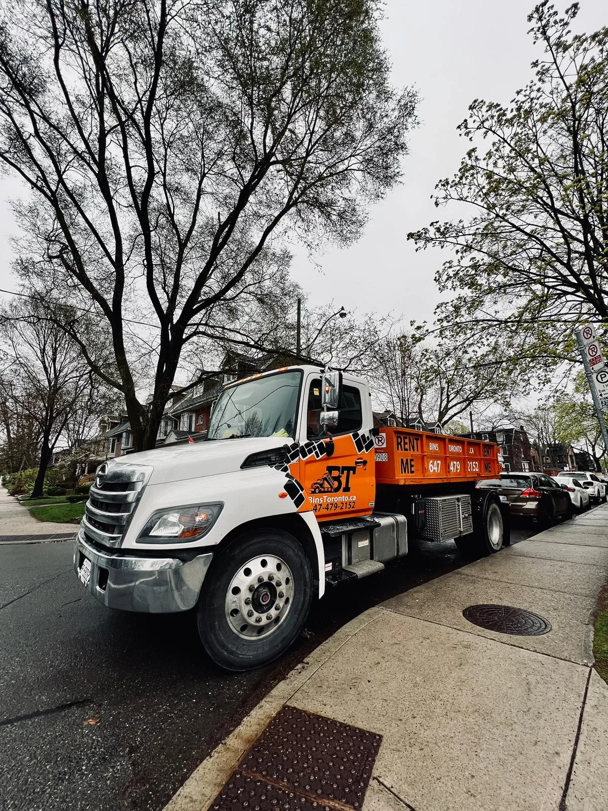 Dumpster placed safely on the street with reflective markers