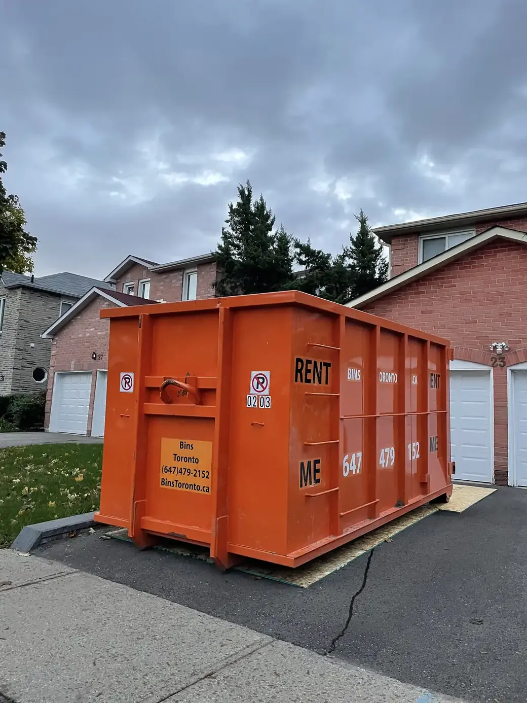Residential dumpster bin placed on a Toronto driveway for a home renovation project